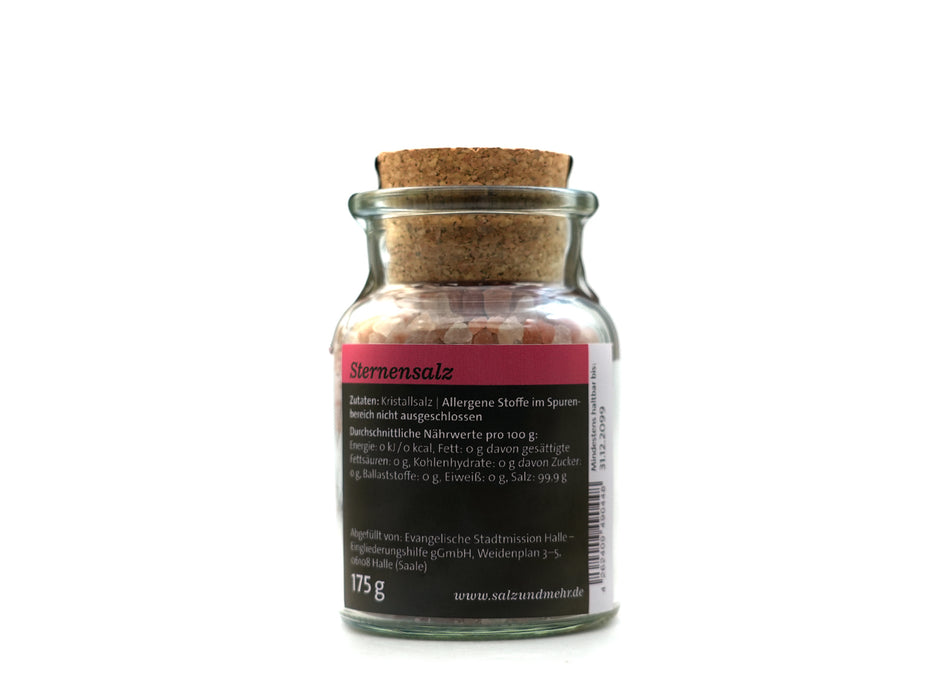 Ein 175-g-Glas Sternensalz groß, gefüllt mit rosa Kristallsalz und mit einem Korkdeckel verschlossen. Das deutsche Etikett zeigt Zutaten und Nährwertangaben. Perfekt für die gehobene Küche, steht es aufrecht auf schlichtem weißem Hintergrund.