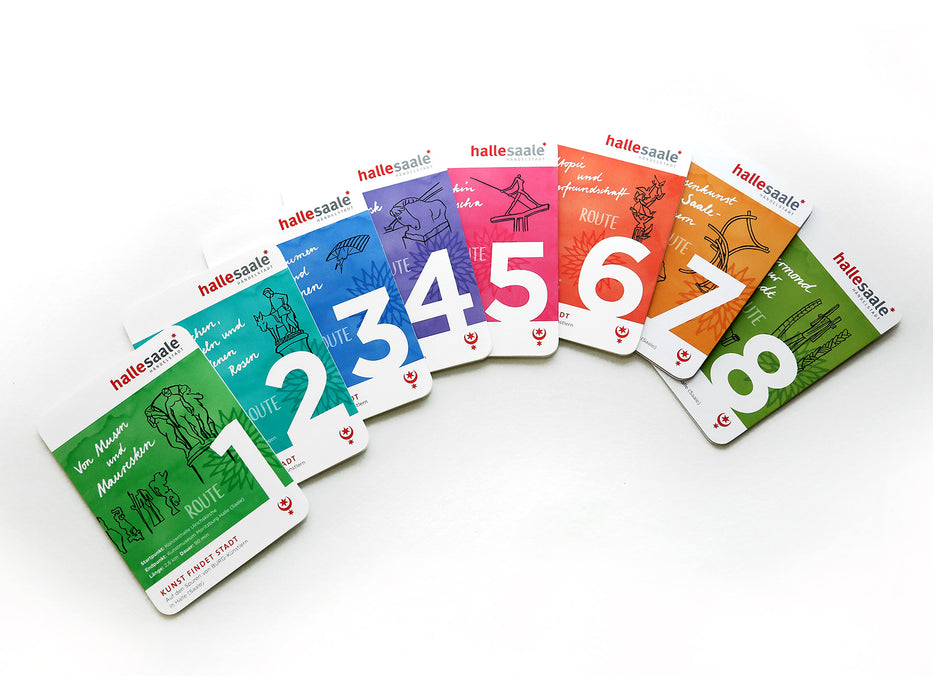 Die Kunststadtplan-Broschüre „Route 4“ ist mit einfachen, charakteristischen Strichzeichnungen und dem Wort „ROUTE“ versehen, wobei „Halle Saale“ als oberster Text auf weißem Hintergrund steht. Sie ist Teil eines farbenfrohen, nummerierten Sets, das in einer fächerartigen Reihe angeordnet ist.