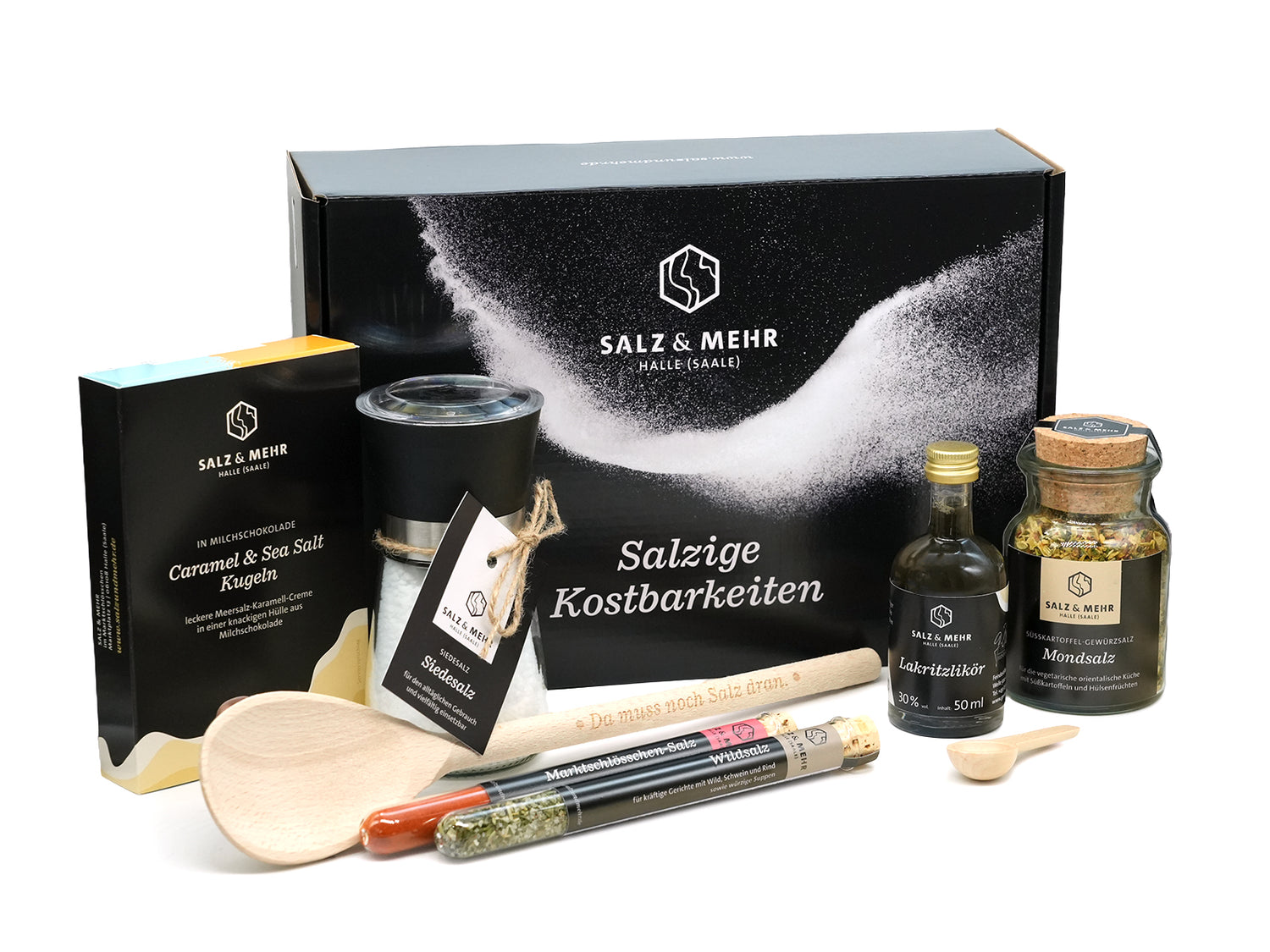 Die Salzbox „Salzige Kostbarkeiten“ beinhaltet besondere Salzsorten, Karamell- & Meersalz-Schokoladen, ein schwarzes Glas, mit Gewürzen gefüllte Glasröhrchen, einen Holzlöffel und ein Salzbüchlein – hübsch arrangiert vor der eleganten schwarzen Salz & Mehr Box.